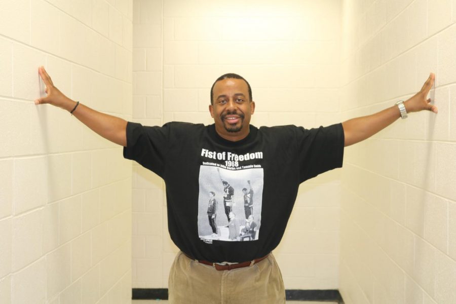 History teacher Erik Wilson wears a graphic tee featuring sprinters Tommy Smith and John Carlos accepting their medals during the 1968 Olympics in Mexico City.  Their raised fists symbolized Black Power during the height of the Civil Rights Movement. 