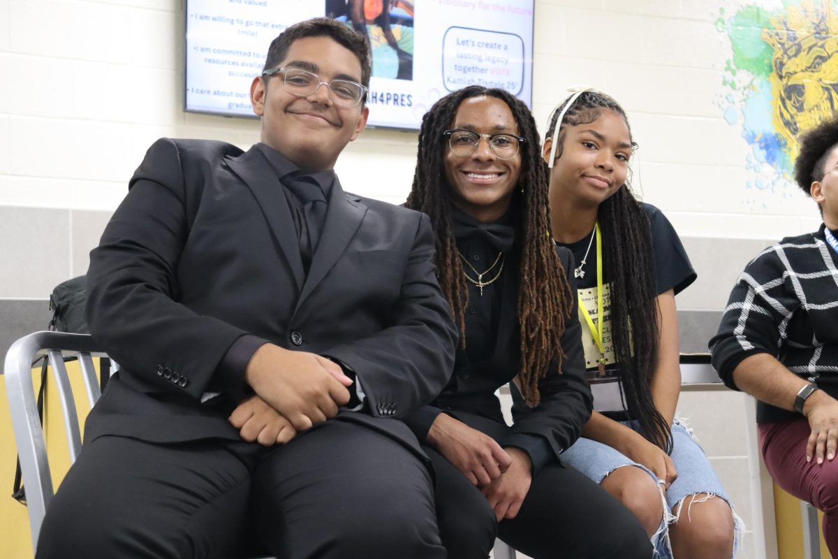 Candidates Dominick Barham, Cameron Love, and Kamiah Tisdale pose for a photo. 