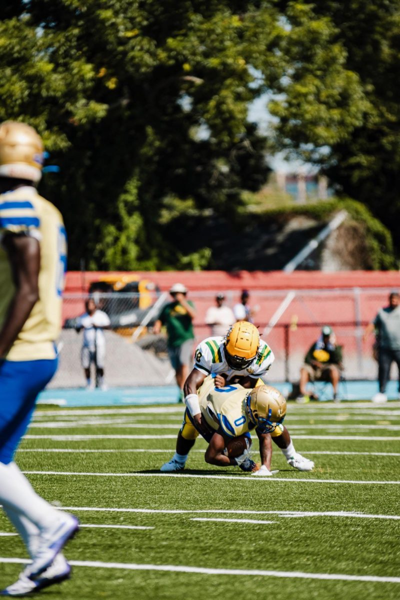 Defensive Tackle Larry Dove making a tackle on Phoebus's running back